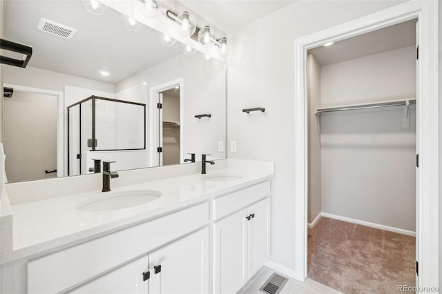 bathroom featuring an enclosed shower and vanity