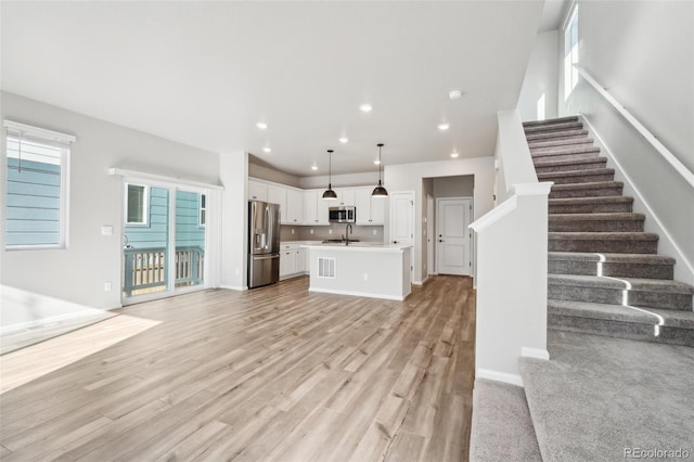 interior space featuring sink and light hardwood / wood-style flooring