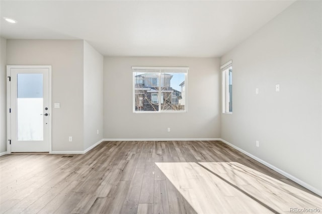 spare room with light hardwood / wood-style flooring