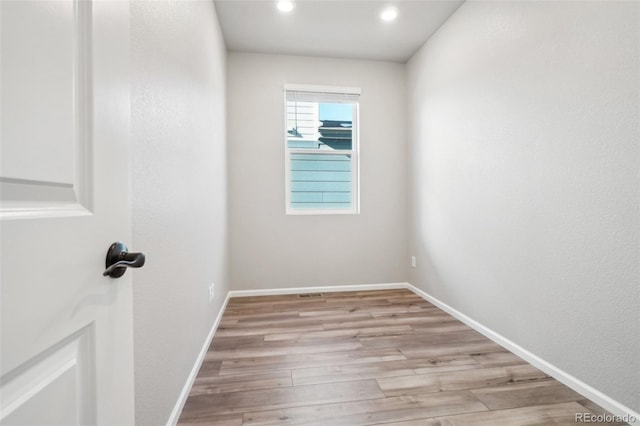 unfurnished room with light wood-type flooring