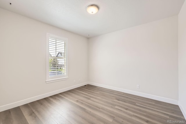 8778 S Quatar St, Aurora, CO 80016 - empty room featuring wood finished floors