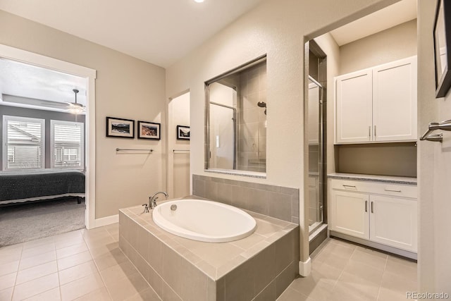 8778 S Quatar St, Aurora, CO 80016 - full bathroom featuring tile patterned flooring, a garden tub, ensuite bathroom, and a stall shower