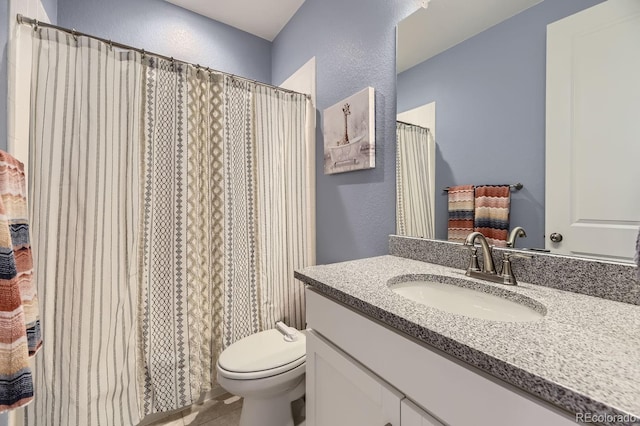 8778 S Quatar St, Aurora, CO 80016 - bathroom featuring a textured wall, vanity, and tile patterned floors