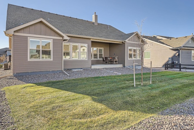 8778 S Quatar St, Aurora, CO 80016 - rear view of house with board and batten siding, a patio, and a shingled roof