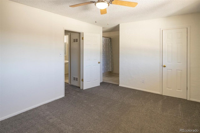 unfurnished bedroom with a textured ceiling, carpet floors, baseboards, and visible vents