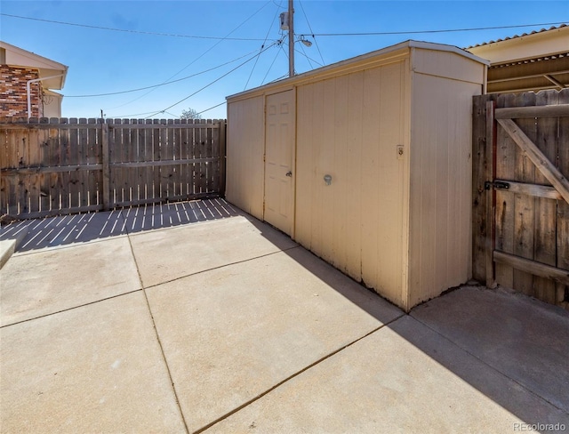 view of shed featuring a gate and fence