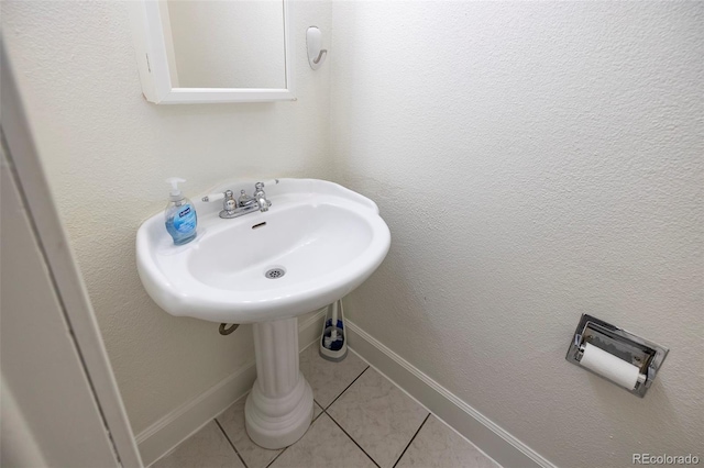 bathroom featuring baseboards and tile patterned floors
