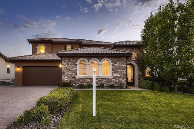 9453 Vista Hill Ln, Lone Tree, CO 80124 - mediterranean / spanish house with an attached garage, stone siding, a front lawn, decorative driveway, and a tile roof