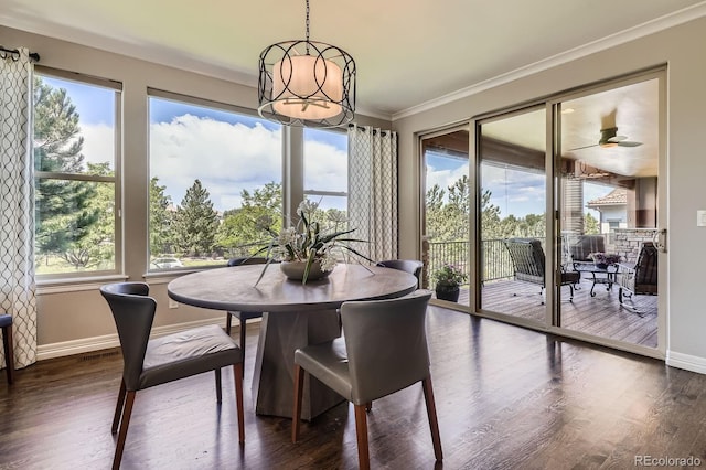 9453 Vista Hill Ln, Lone Tree, CO 80124 - dining space featuring ornamental molding, dark wood-style floors, healthy amount of natural light, and a chandelier
