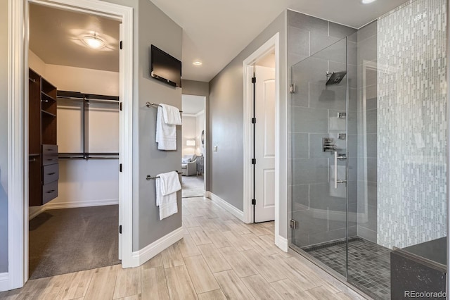 9453 Vista Hill Ln, Lone Tree, CO 80124 - full bathroom featuring a stall shower, a spacious closet, wood finished floors, and recessed lighting