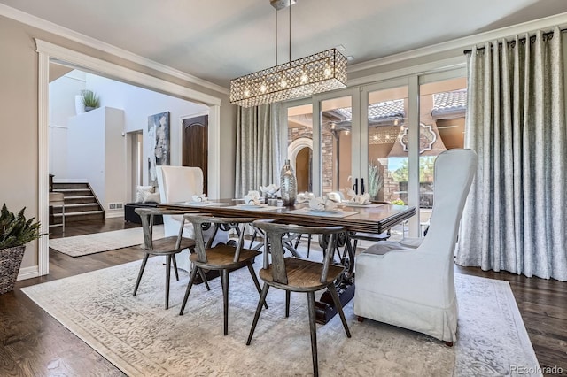 9453 Vista Hill Ln, Lone Tree, CO 80124 - dining area featuring ornamental molding, wood finished floors, a chandelier, and stairway