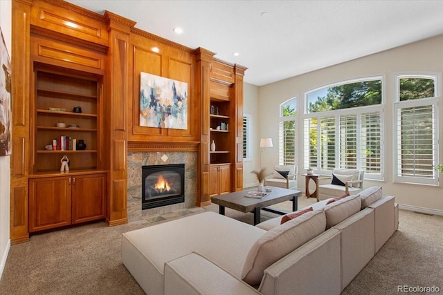 6703 S Yates Ct, Littleton, CO 80128 - living area featuring light carpet, a tile fireplace, recessed lighting, and built in features