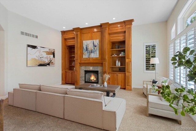 6703 S Yates Ct, Littleton, CO 80128 - living area featuring light carpet, a fireplace, built in shelves, and recessed lighting