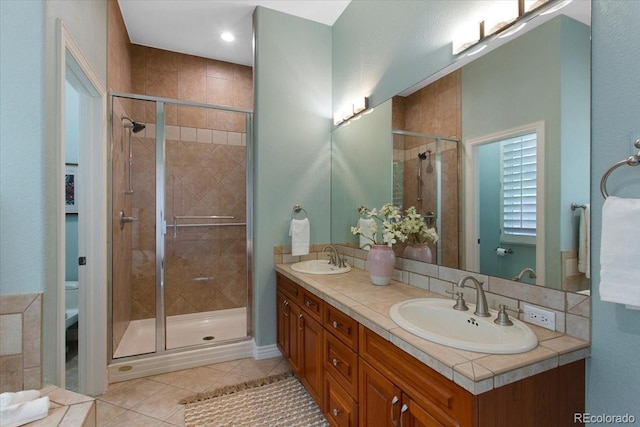 6703 S Yates Ct, Littleton, CO 80128 - bathroom with double vanity, tile patterned flooring, and a shower stall