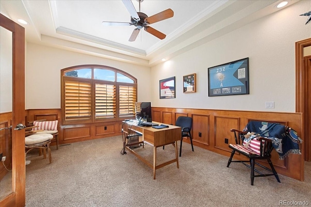 6703 S Yates Ct, Littleton, CO 80128 - home office featuring a wainscoted wall, crown molding, light colored carpet, ceiling fan, and a tray ceiling