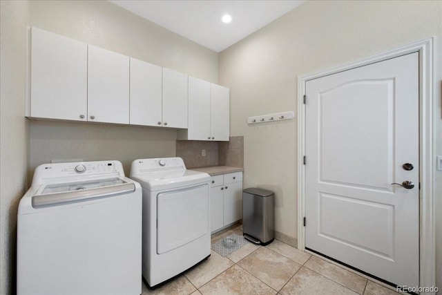 6703 S Yates Ct, Littleton, CO 80128 - laundry area featuring cabinet space, washer and dryer, light tile patterned floors, and recessed lighting