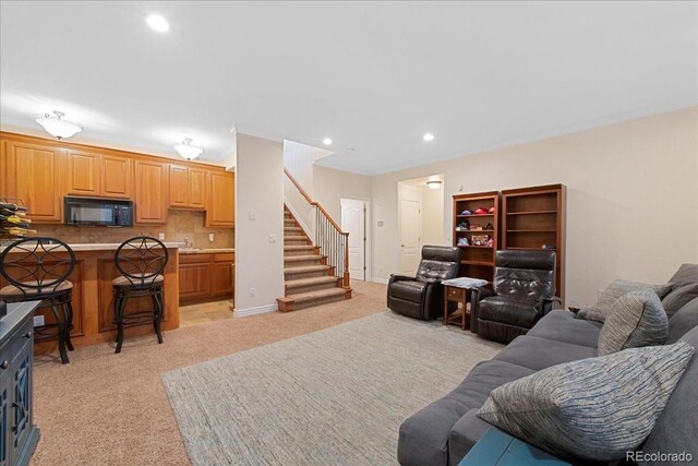 6703 S Yates Ct, Littleton, CO 80128 - living room with light carpet, ornamental molding, stairs, and recessed lighting