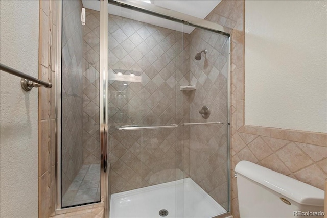 6703 S Yates Ct, Littleton, CO 80128 - full bath with a shower stall, tile walls, and a textured wall