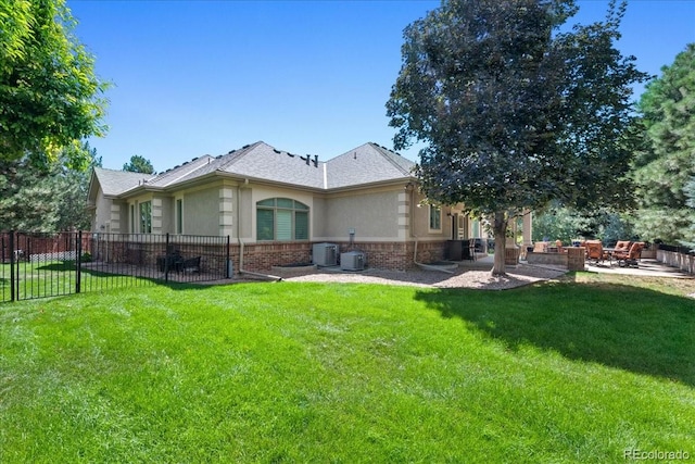 6703 S Yates Ct, Littleton, CO 80128 - back of property with a patio area, brick siding, and stucco siding