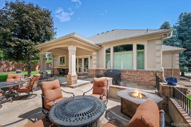 6703 S Yates Ct, Littleton, CO 80128 - view of patio featuring a grill and an outdoor fire pit