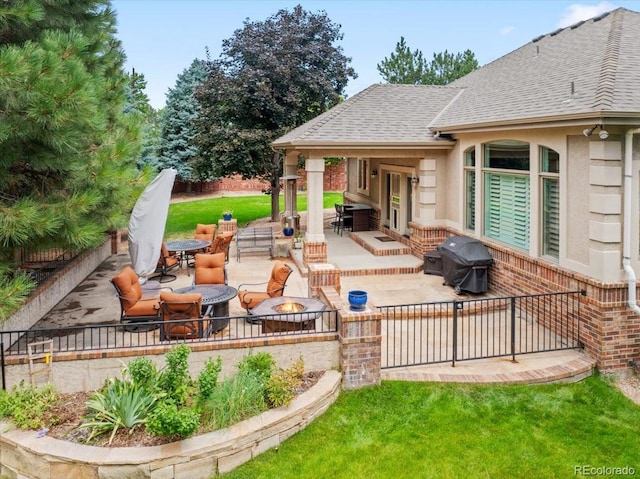 6703 S Yates Ct, Littleton, CO 80128 - view of patio with a grill, a fire pit, and outdoor dining area