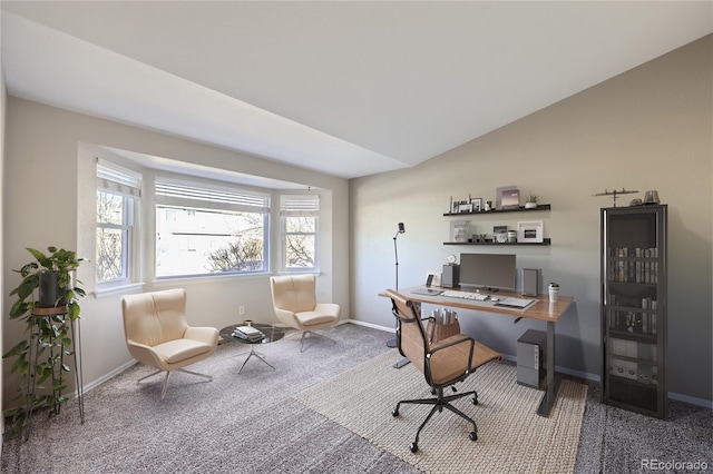 home office featuring lofted ceiling and carpet flooring