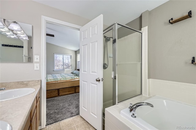 bathroom featuring tile patterned floors, vanity, independent shower and bath, and vaulted ceiling