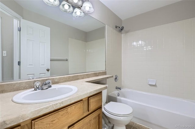 full bathroom with tiled shower / bath, vanity, and toilet