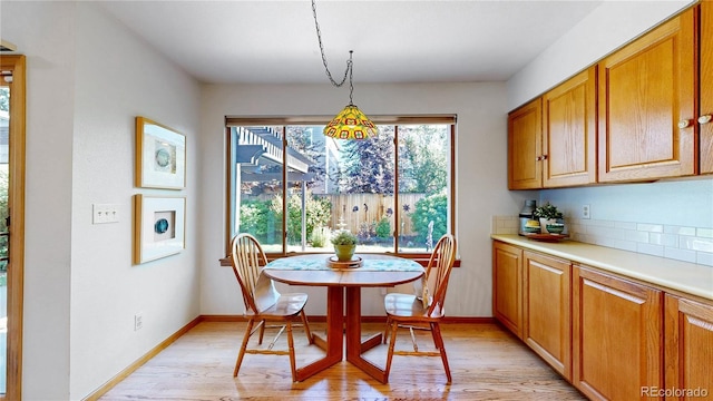 14633 W 69th Pl, Arvada, CO 80004 - dining space featuring light wood-style flooring and baseboards