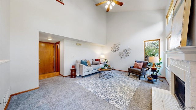 14633 W 69th Pl, Arvada, CO 80004 - living room featuring a towering ceiling, light colored carpet, a brick fireplace, and ceiling fan