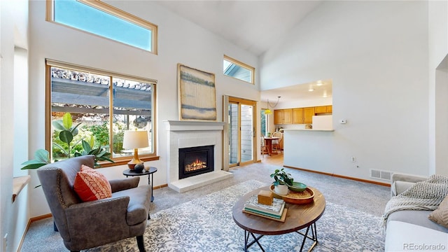 14633 W 69th Pl, Arvada, CO 80004 - living area with high vaulted ceiling, light colored carpet, and a fireplace