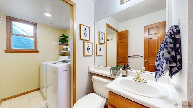 14633 W 69th Pl, Arvada, CO 80004 - bathroom featuring washing machine and dryer, vanity, and tile patterned floors