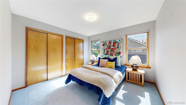 14633 W 69th Pl, Arvada, CO 80004 - bedroom with two closets, multiple windows, and light carpet