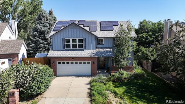 14633 W 69th Pl, Arvada, CO 80004 - view of front of property with board and batten siding, an attached garage, concrete driveway, and brick siding