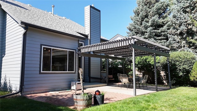 14633 W 69th Pl, Arvada, CO 80004 - back of house with a pergola, a patio, a chimney, a shingled roof, and a lawn