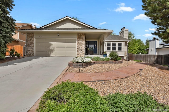 7466 E Long Cir, Centennial, CO 80112 - view of front of property featuring driveway, a garage, fence, roof with shingles, and stone siding