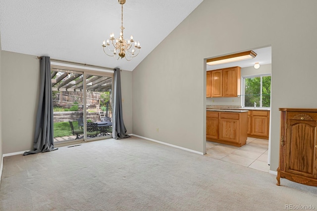 7466 E Long Cir, Centennial, CO 80112 - unfurnished dining area with light colored carpet, a chandelier, high vaulted ceiling, baseboards, and a sink