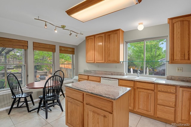 7466 E Long Cir, Centennial, CO 80112 - kitchen featuring a sink, dishwasher, light tile patterned flooring, light stone countertops, and a center island