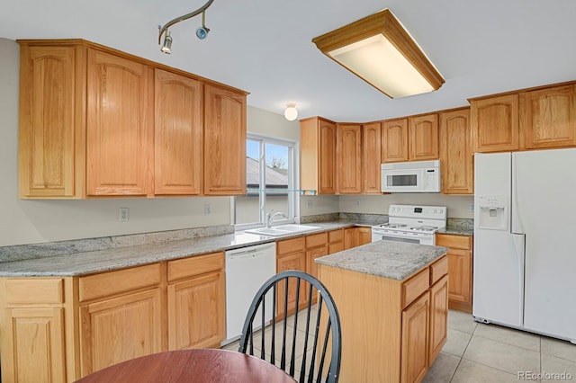 7466 E Long Cir, Centennial, CO 80112 - kitchen featuring white appliances, a sink, a center island, light tile patterned flooring, and light stone counters