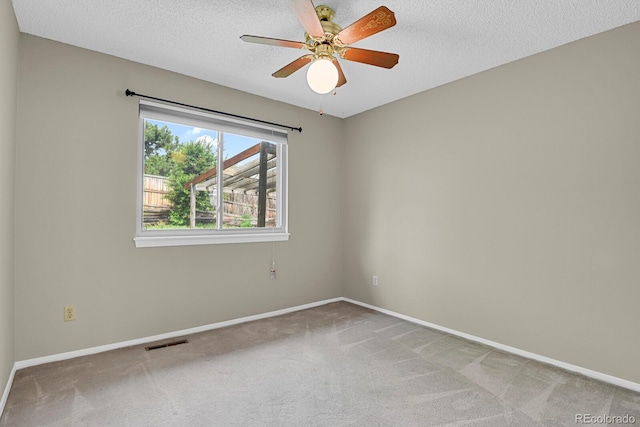 7466 E Long Cir, Centennial, CO 80112 - spare room featuring light carpet, baseboards, and a textured ceiling