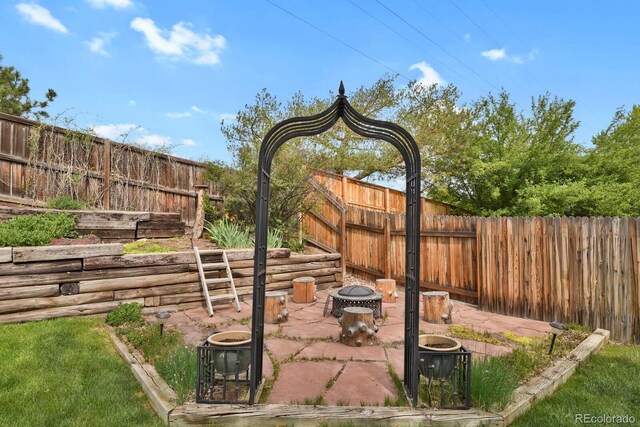7466 E Long Cir, Centennial, CO 80112 - fenced backyard with a patio area and a fire pit