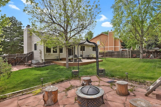 7466 E Long Cir, Centennial, CO 80112 - rear view of property featuring a fire pit, a deck, a patio, and a chimney