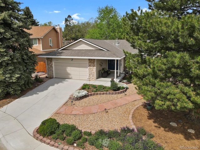 7466 E Long Cir, Centennial, CO 80112 - view of front of home featuring a shingled roof, a garage, stone siding, and driveway