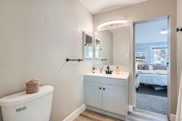 bathroom featuring hardwood / wood-style floors, vanity, and toilet