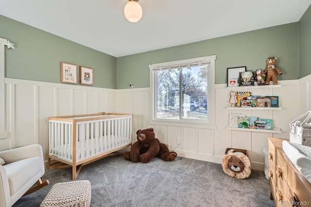 bedroom featuring carpet and a nursery area