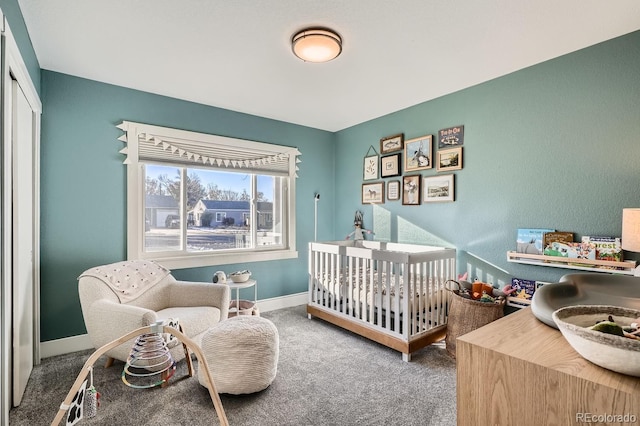 bedroom with a crib and carpet flooring