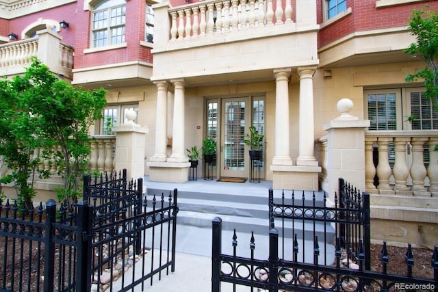 1950 N Logan St Unit 102, Denver, CO 80203 - property entrance with a porch, stone siding, and a balcony