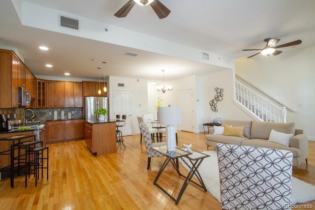 1950 N Logan St Unit 102, Denver, CO 80203 - living area with a ceiling fan, light wood-style floors, stairway, recessed lighting, and a chandelier