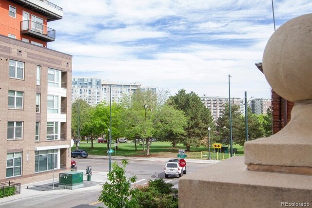 1950 N Logan St Unit 102, Denver, CO 80203 - view of asphalt street featuring traffic signs, sidewalks, and curbs