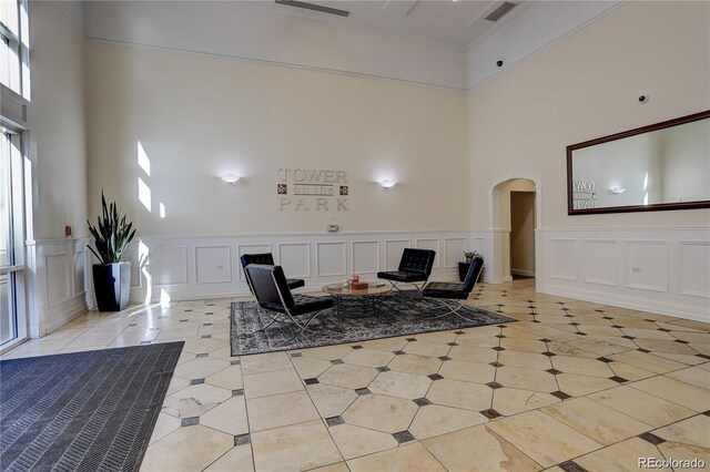 1950 N Logan St Unit 102, Denver, CO 80203 - community lobby with a towering ceiling, a decorative wall, and wainscoting